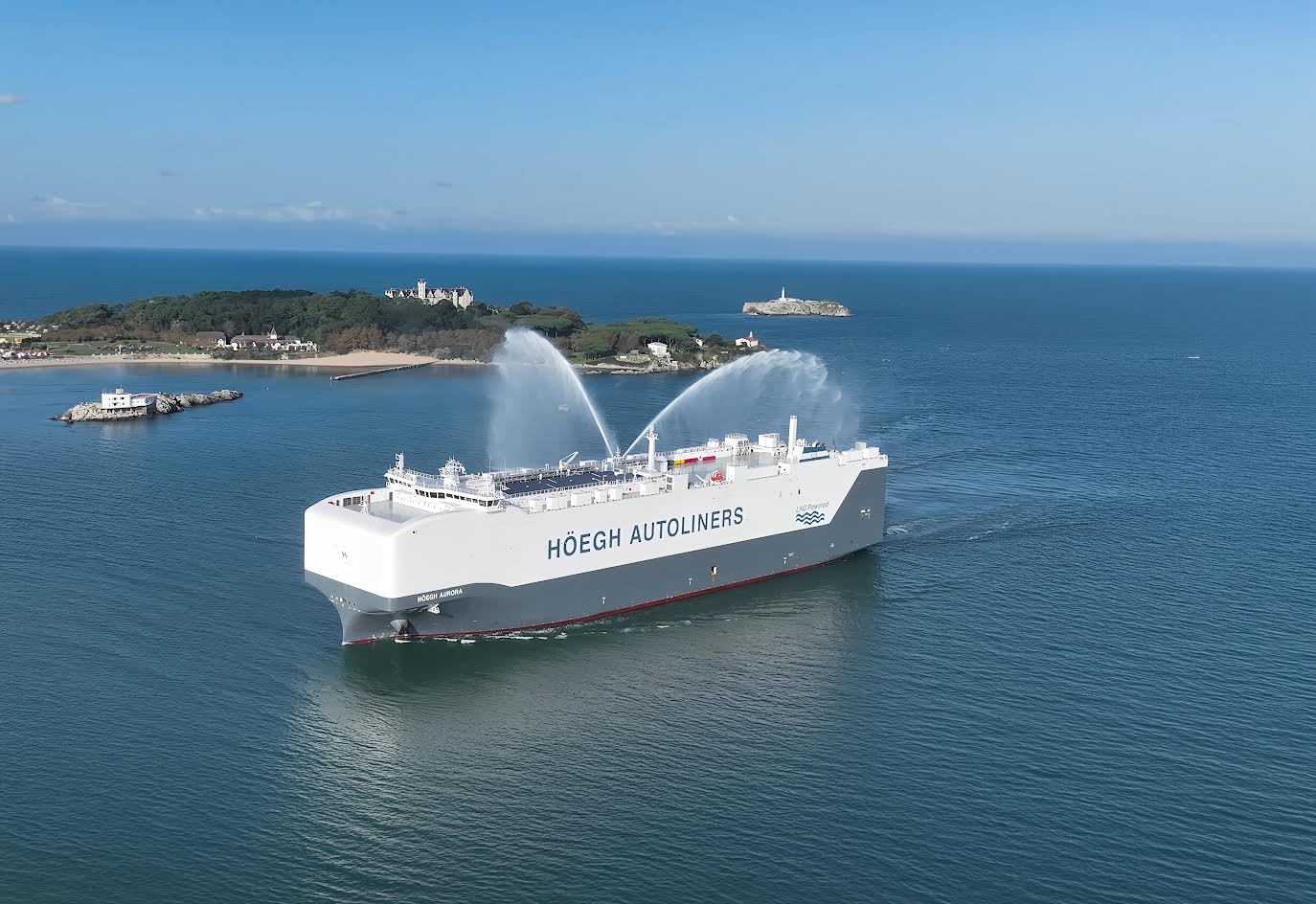 A large car carrier vessel, part of Höegh Autoliners' fleet, sailing on the open sea.